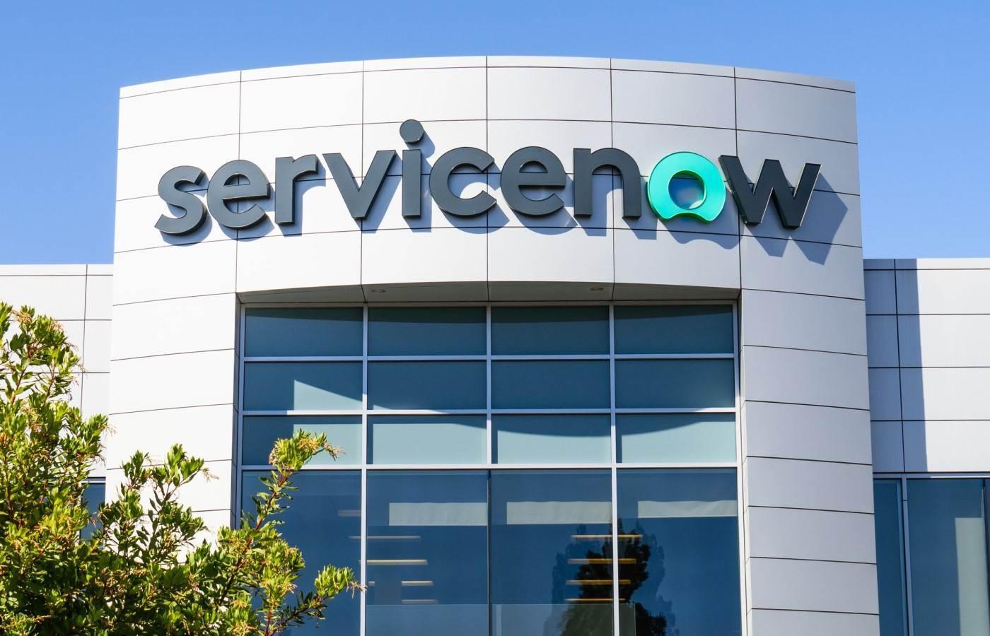 A company building with the logo ServiceNow above the entrance doors